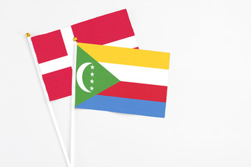 Comoros and Denmark stick flags on white background. High quality fabric, miniature national flag....