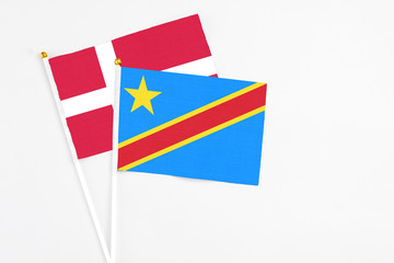 Congo and Denmark stick flags on white background. High quality fabric, miniature national flag. Peaceful global concept.White floor for copy space.