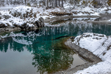 Beautiful blue ice-free lake of Siberia in winter. Katun river in winter. Russia, Altai Region, Siberia.
