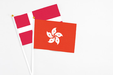 Hong Kong and Denmark stick flags on white background. High quality fabric, miniature national flag. Peaceful global concept.White floor for copy space.