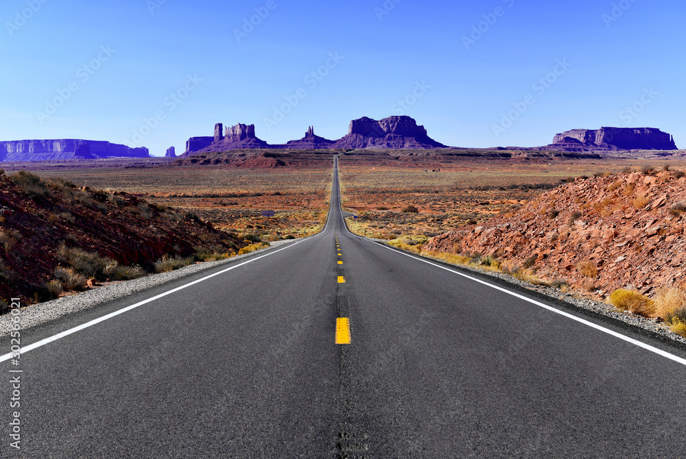 Wall mural road into the red rock desert landscape of monument valley, navajo tribal park in the southwest usa 