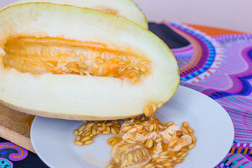 Fresh melon on a wooden chopping Board.