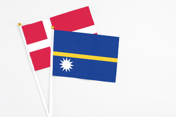 Nauru and Denmark stick flags on white background. High quality fabric, miniature national flag. Peaceful global concept.White floor for copy space.