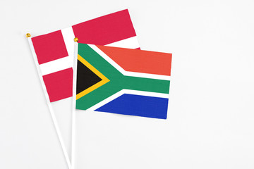 South Africa and Denmark stick flags on white background. High quality fabric, miniature national flag. Peaceful global concept.White floor for copy space.