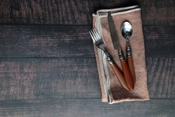 Flat lay background of a napkin and cutlery with copy space.