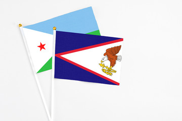 American Samoa and Djibouti stick flags on white background. High quality fabric, miniature...