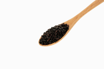 black rice in spoon with white background