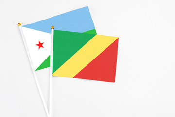 Republic Of The Congo and Djibouti stick flags on white background. High quality fabric, miniature national flag. Peaceful global concept.White floor for copy space.