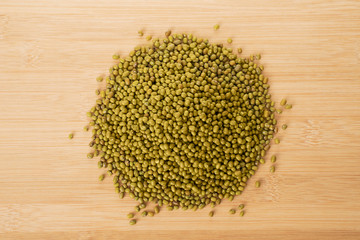 mung bean pile and wooden spoon on wooden table
