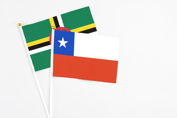 Chile and Dominica stick flags on white background. High quality fabric, miniature national flag. Peaceful global concept.White floor for copy space.