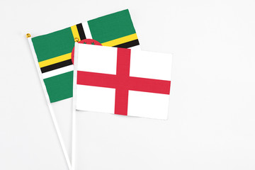 England and Dominica stick flags on white background. High quality fabric, miniature national flag....