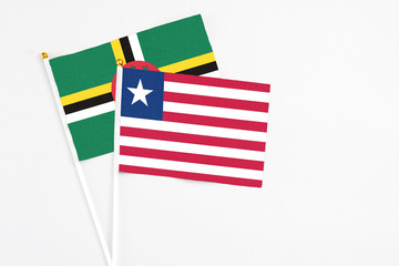 Liberia and Dominica stick flags on white background. High quality fabric, miniature national flag....