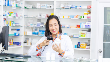 Pharmacist working in pharmacy shop or chemist shop with medication drugstore.