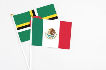 Mexico and Dominica stick flags on white background. High quality fabric, miniature national flag....