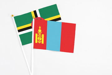 Mongolia and Dominica stick flags on white background. High quality fabric, miniature national flag. Peaceful global concept.White floor for copy space.