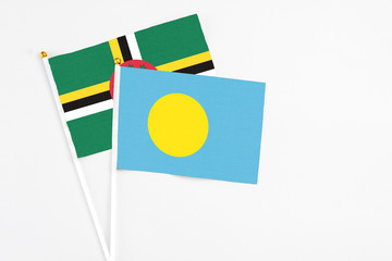 Palau and Dominica stick flags on white background. High quality fabric, miniature national flag....