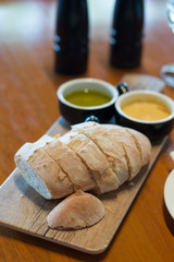 Handmade Bread Loaf and olive oil and Miso butter on a wooden platter