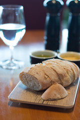 Handmade Bread Loaf and olive oil and Miso butter on a wooden platter