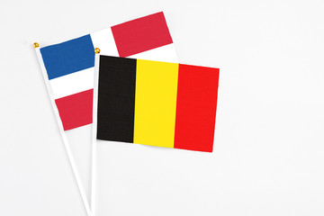 Belgium and Dominican Republic stick flags on white background. High quality fabric, miniature national flag. Peaceful global concept.White floor for copy space.