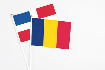 Chad and Dominican Republic stick flags on white background. High quality fabric, miniature...