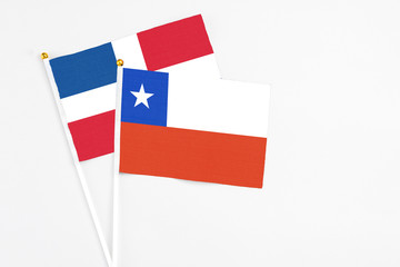 Chile and Dominican Republic stick flags on white background. High quality fabric, miniature national flag. Peaceful global concept.White floor for copy space.