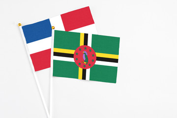 Dominica and Dominican Republic stick flags on white background. High quality fabric, miniature...