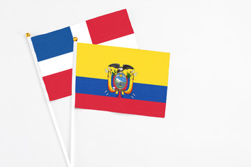 Ecuador and Dominican Republic stick flags on white background. High quality fabric, miniature national flag. Peaceful global concept.White floor for copy space.