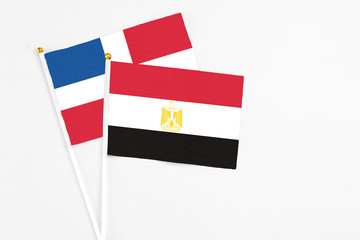 Egypt and Dominican Republic stick flags on white background. High quality fabric, miniature national flag. Peaceful global concept.White floor for copy space.