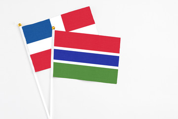 Gambia and Dominican Republic stick flags on white background. High quality fabric, miniature...