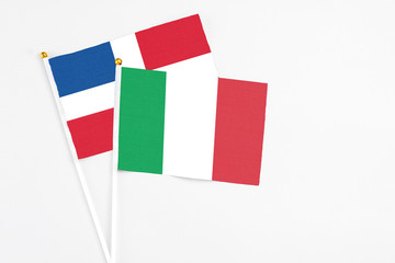 Italy and Dominican Republic stick flags on white background. High quality fabric, miniature national flag. Peaceful global concept.White floor for copy space.