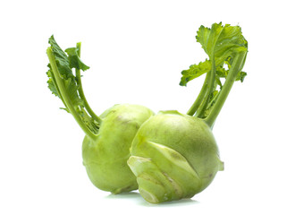 Fresh kohlrabi with green leaves on isolated white