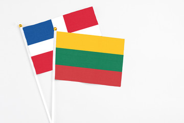 Lithuania and Dominican Republic stick flags on white background. High quality fabric, miniature national flag. Peaceful global concept.White floor for copy space.