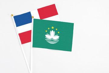 Macao and Dominican Republic stick flags on white background. High quality fabric, miniature national flag. Peaceful global concept.White floor for copy space.