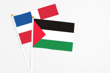 Palestine and Dominican Republic stick flags on white background. High quality fabric, miniature...