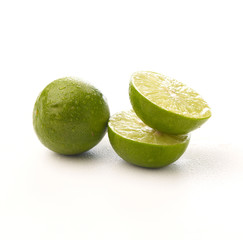 Limes with half isolated on white background