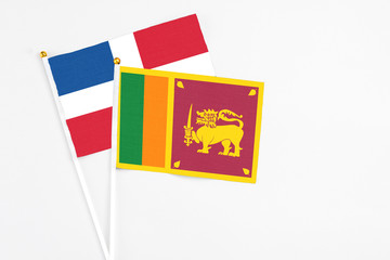 Sri Lanka and Dominican Republic stick flags on white background. High quality fabric, miniature national flag. Peaceful global concept.White floor for copy space.