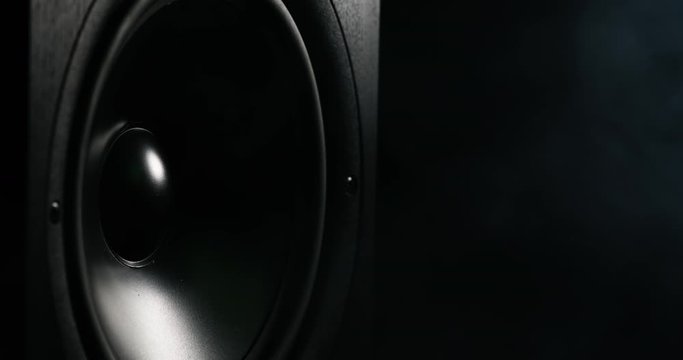 CLOSE UP moving sub-woofer music speakers vibrating membrane colorful pulsing light haze smoke