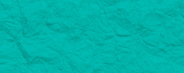 Crumpled turquoise paper texture background