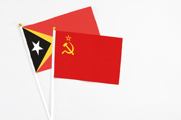 Soviet Union and East Timor stick flags on white background. High quality fabric, miniature national flag. Peaceful global concept.White floor for copy space.