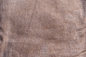 Fototapeta na wymiar Surface of dark brown color corduroy cloth which is cotton and stretch Polyurethane.