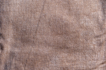Surface of dark brown color corduroy cloth which is cotton and stretch Polyurethane.