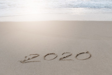 2020 written in the sand on the beach