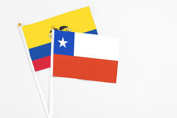 Chile and Ecuador stick flags on white background. High quality fabric, miniature national flag. Peaceful global concept.White floor for copy space.