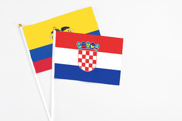 Croatia and Ecuador stick flags on white background. High quality fabric, miniature national flag. Peaceful global concept.White floor for copy space.