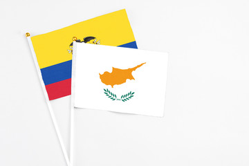 Cyprus and Ecuador stick flags on white background. High quality fabric, miniature national flag. Peaceful global concept.White floor for copy space.