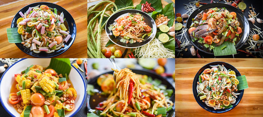 Photo Mix Thai Food papaya salad served on dining table / Green papaya salad spicy on plate vegetables corn herbs and spices seafood shrimp crab noodles salted egg Som tum Thai menu Asian food