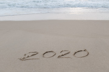 2020 written in the sand on the beach