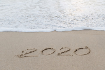 2020 written in the sand on the beach