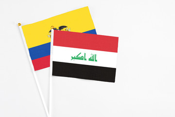 Iraq and Ecuador stick flags on white background. High quality fabric, miniature national flag. Peaceful global concept.White floor for copy space.