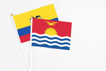 Kiribati and Ecuador stick flags on white background. High quality fabric, miniature national flag. Peaceful global concept.White floor for copy space.